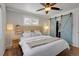 Bright bedroom featuring modern decor and a barn door leading to the walk-in closet at 748 S Grape St, Denver, CO 80246