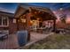 Outdoor covered patio with a dining table, barbecue, outdoor furniture, and ambient lighting at 748 S Grape St, Denver, CO 80246