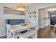 Bright dining area with white table and bench seating, featuring a custom upholstered banquette at 748 S Grape St, Denver, CO 80246