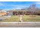 Traditional brick home with inviting front yard, featuring a manicured lawn and mature landscaping at 748 S Grape St, Denver, CO 80246