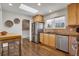 Bright kitchen featuring stainless steel appliances, a skylight, and a breakfast bar area at 748 S Grape St, Denver, CO 80246