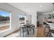 Charming dining area with a round table, stylish chairs, and natural light from two windows at 1337 N Alton St, Aurora, CO 80010