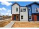 New two-story home featuring a mix of brick, white, and blue siding with a paved walkway at 1337 N Alton St, Aurora, CO 80010