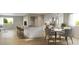 Bright kitchen features a large island, breakfast bar, and an adjacent dining area with modern decor and natural light at 1337 N Alton St, Aurora, CO 80010