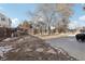 Spacious fenced backyard with a concrete patio and mature trees at 13033 Birch Dr, Thornton, CO 80241