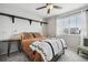 Cozy bedroom with floating shelves, ceiling fan, and natural light from a window at 13033 Birch Dr, Thornton, CO 80241