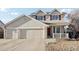 Inviting two-story home with a three car garage, and landscaped front yard at 13033 Birch Dr, Thornton, CO 80241