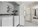 Functional laundry area with modern appliances and storage shelving at 13033 Birch Dr, Thornton, CO 80241