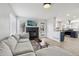 Bright living room with a black brick fireplace and an open layout to the kitchen at 13033 Birch Dr, Thornton, CO 80241