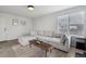 Spacious living room featuring stylish furniture, great light, and wood laminate flooring at 13033 Birch Dr, Thornton, CO 80241