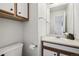 Cozy half bath with wood cabinets, toilet, and vanity sink at 13033 Birch Dr, Thornton, CO 80241