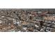Expansive aerial view of neighborhood, showing mix of housing styles and mature trees on a cloudy day at 3251 N Madison St, Denver, CO 80205