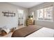 Bedroom featuring neutral-toned walls, hardwood floors, and a window view of the neighborhood at 3251 N Madison St, Denver, CO 80205