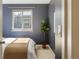 Cozy bedroom with a comfortable bed, soft lighting, and a plant by the window at 3251 N Madison St, Denver, CO 80205