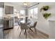 Eat-in kitchen featuring a modern glass dining table and outdoor views through the sliding doors at 3251 N Madison St, Denver, CO 80205