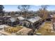 Charming home with landscaped front yard, inviting porch, fenced yard, and Denver skyline at 3251 N Madison St, Denver, CO 80205