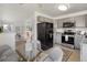 Bright eat-in kitchen featuring grey cabinets, stainless steel appliances, and a glass dining table at 3251 N Madison St, Denver, CO 80205