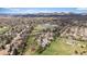 Expansive aerial view of the community featuring lush landscapes, lake, and mountain backdrop at 10624 W Berry Pl, Littleton, CO 80127