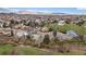 Wide aerial shot of a community with well-spaced homes, green spaces, and scenic mountain views in the distance at 10624 W Berry Pl, Littleton, CO 80127