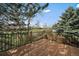 Wood back deck with black metal railing with an open green space in the background at 10624 W Berry Pl, Littleton, CO 80127