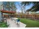 Backyard view with artificial grass, patio and upper balcony, perfect for outdoor entertaining at 10624 W Berry Pl, Littleton, CO 80127