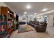 Open basement featuring plush carpeting, a large TV, and ample seating, perfect for entertaining at 10624 W Berry Pl, Littleton, CO 80127