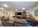 Large finished basement area with lots of seating, perfect for entertaining guests and relaxation at 10624 W Berry Pl, Littleton, CO 80127