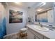 Bright bathroom featuring a large vanity, modern fixtures, a colorful painting and decorative details at 10624 W Berry Pl, Littleton, CO 80127