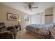 Cozy bedroom with neutral colored walls, a ceiling fan, an armchair, and a closet at 10624 W Berry Pl, Littleton, CO 80127