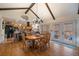 Dining area featuring a wooden table, six chairs and seamless access to the kitchen and patio at 10624 W Berry Pl, Littleton, CO 80127