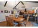 Dining room with direct sightlines to the kitchen, ample seating, and stylish chandelier at 10624 W Berry Pl, Littleton, CO 80127
