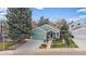 Charming home featuring a well-manicured front yard, two-car garage, and inviting entryway at 10624 W Berry Pl, Littleton, CO 80127