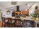 Modern kitchen with an island, pendant lighting, black stainless steel appliances, and stone countertops at 10624 W Berry Pl, Littleton, CO 80127