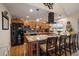 Well-appointed kitchen featuring an eat-in island, stainless steel appliances, and wooden cabinetry at 10624 W Berry Pl, Littleton, CO 80127
