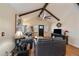 Bright living room with beamed ceilings, hardwood floors, and stylish furniture at 10624 W Berry Pl, Littleton, CO 80127