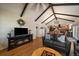 Cozy living room with beam ceilings flowing into the kitchen and dining area at 10624 W Berry Pl, Littleton, CO 80127