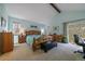 Bright main bedroom with vaulted ceilings, a private balcony, and light blue walls at 10624 W Berry Pl, Littleton, CO 80127