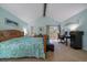 Bright main bedroom with vaulted ceilings, a private balcony, and light blue walls at 10624 W Berry Pl, Littleton, CO 80127