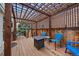 Relaxing patio area with wooden pergola, stylish blue chairs and cozy firepit for outdoor enjoyment at 10624 W Berry Pl, Littleton, CO 80127