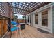 Inviting patio with pergola, string lights, and outdoor seating, perfect for relaxing and entertaining at 10624 W Berry Pl, Littleton, CO 80127