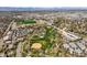 Aerial view of a neighborhood featuring green spaces, baseball fields, and walking trails at 5485 S Lakeview St, Littleton, CO 80120