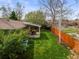 Lush backyard featuring a covered patio, green lawn, and a wooden fence at 5485 S Lakeview St, Littleton, CO 80120