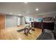 Spacious basement with hardwood floors and exercise equipment, offering a versatile living space at 5485 S Lakeview St, Littleton, CO 80120