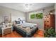 Comfortable bedroom featuring a ceiling fan, hardwood floors, and a bright window at 5485 S Lakeview St, Littleton, CO 80120