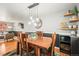 Charming dining room with hardwood floors, modern lighting fixture, and comfortable seating at 5485 S Lakeview St, Littleton, CO 80120