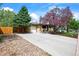 Charming brick home with a well-maintained front yard, featuring mature trees and a driveway at 5485 S Lakeview St, Littleton, CO 80120