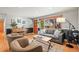 Bright living room with hardwood floors, comfortable seating, and a large window at 5485 S Lakeview St, Littleton, CO 80120