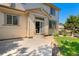 Exterior view of the home with concrete patio and manicured lawn at 13794 E Caley Dr, Englewood, CO 80111