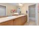 Bathroom with double sinks, tiled backsplash, and walk-in shower at 13794 E Caley Dr, Englewood, CO 80111