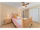 Cozy bedroom featuring a wooden bed frame, bright bedding, and a bedside table, perfect for rest and relaxation at 13794 E Caley Dr, Englewood, CO 80111